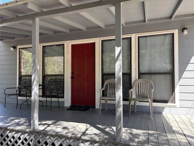 view of exterior entry featuring a wooden deck