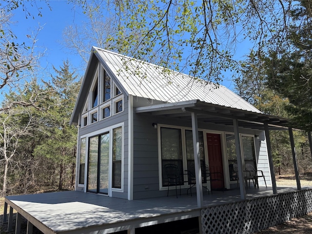 exterior space with metal roof and a deck