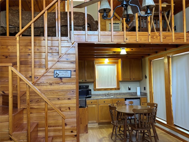 kitchen with a sink, dishwasher, and light wood finished floors