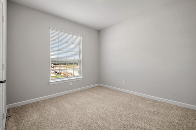 unfurnished room with baseboards and carpet floors