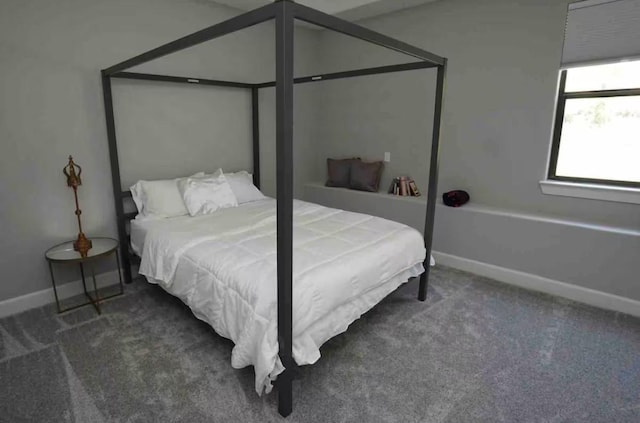 carpeted bedroom featuring baseboards