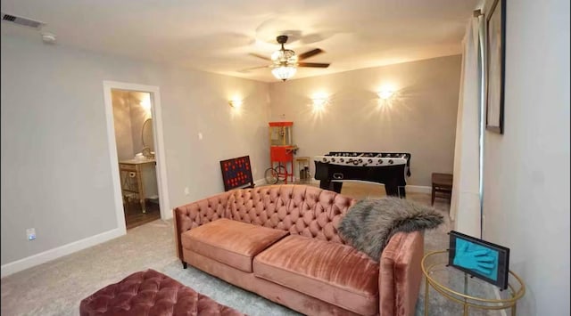 living room with visible vents, baseboards, carpet floors, and a ceiling fan