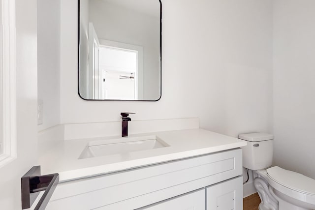 bathroom featuring toilet and vanity