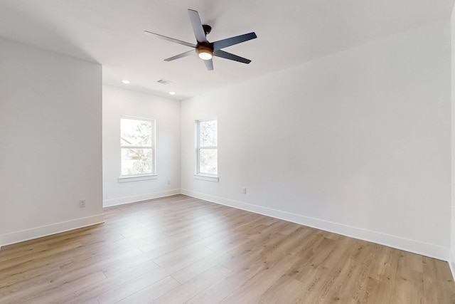 spare room with a ceiling fan, visible vents, baseboards, recessed lighting, and light wood-type flooring