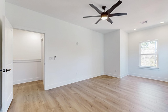 unfurnished room featuring visible vents, baseboards, ceiling fan, and light wood finished floors