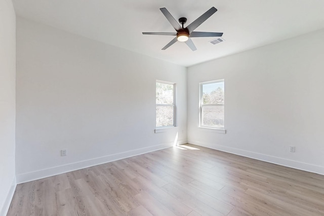 empty room featuring ceiling fan, visible vents, baseboards, and light wood-style flooring