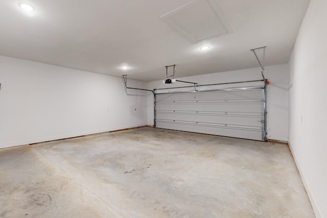 garage featuring a garage door opener and baseboards