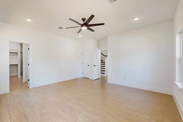 spare room with recessed lighting, visible vents, stairs, and light wood finished floors