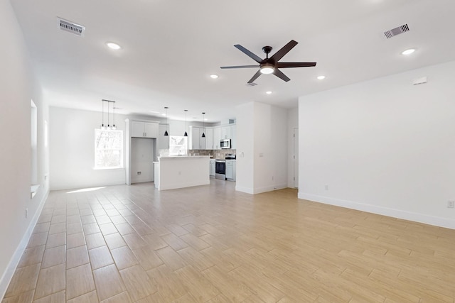 unfurnished living room featuring light wood-type flooring, visible vents, ceiling fan, and recessed lighting