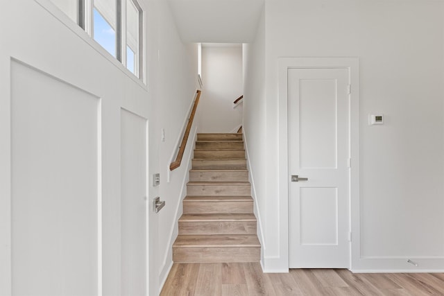 stairway with wood finished floors