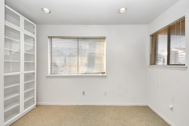 unfurnished room with recessed lighting, light colored carpet, and baseboards