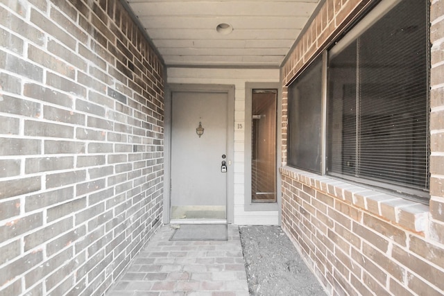 property entrance with brick siding