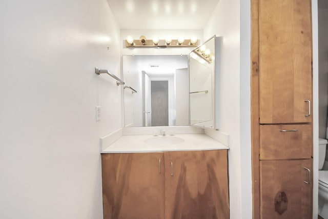 bathroom with toilet and vanity