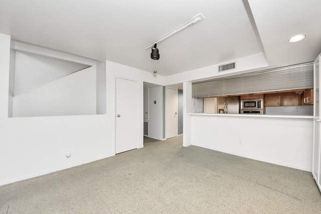 unfurnished living room featuring visible vents and carpet flooring