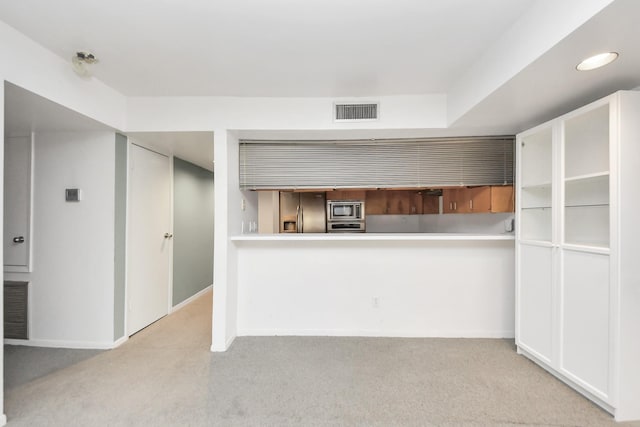 kitchen with visible vents, carpet flooring, stainless steel appliances, and baseboards