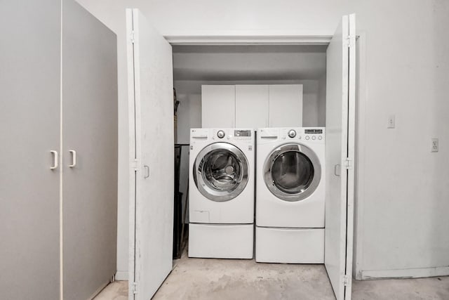 laundry area with cabinet space and washer and dryer