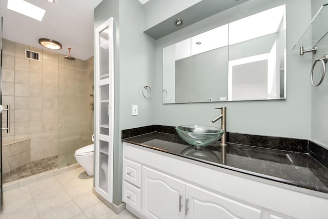 bathroom featuring tile patterned floors, visible vents, toilet, a stall shower, and vanity