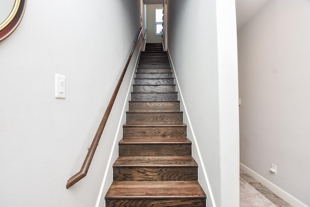 stairway featuring baseboards