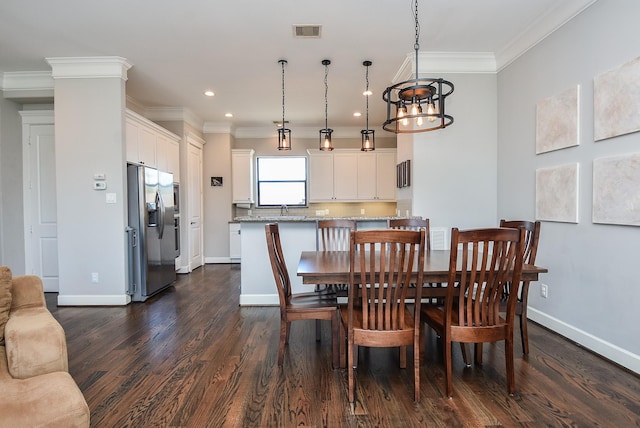 dining space with visible vents, baseboards, ornamental molding, and dark wood-style flooring