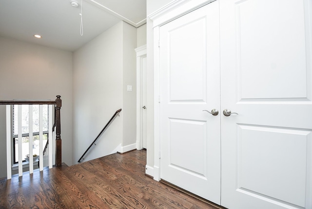 corridor featuring an upstairs landing, recessed lighting, and dark wood-type flooring