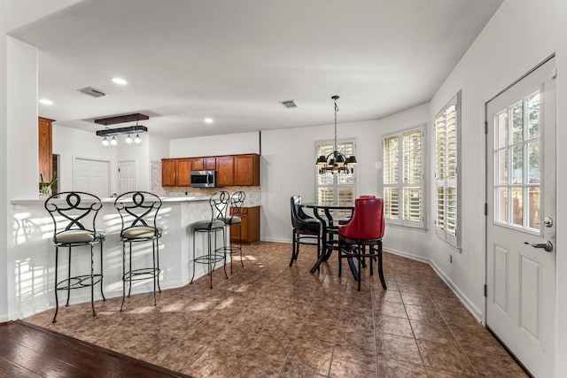 dining area featuring an inviting chandelier, recessed lighting, baseboards, and visible vents