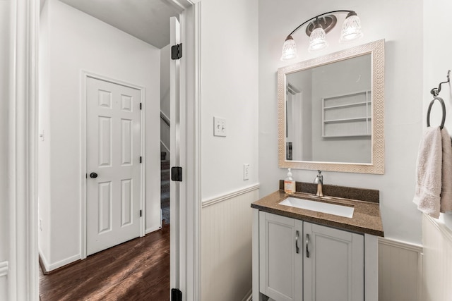 bathroom featuring vanity, wood finished floors, and wainscoting