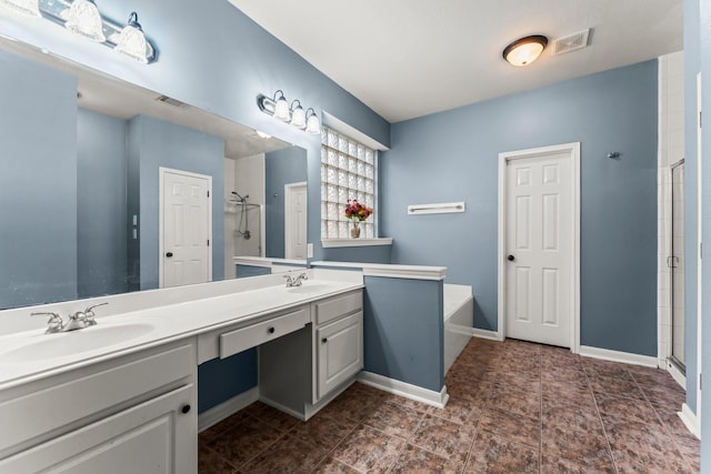 full bath featuring visible vents, a shower stall, and a sink