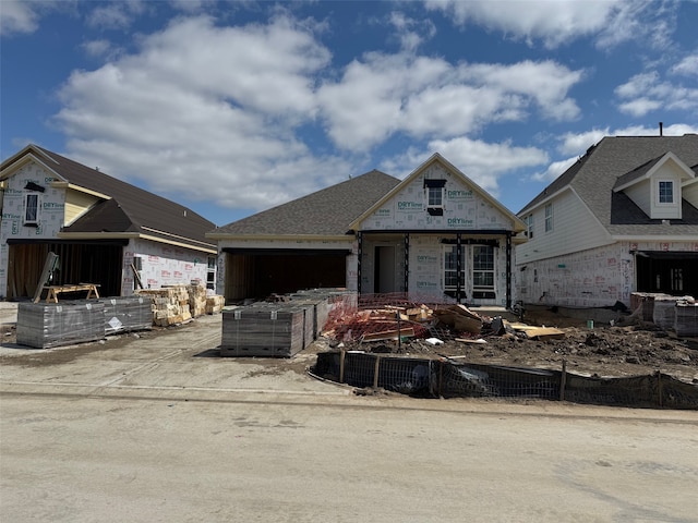 property under construction featuring a garage and fence