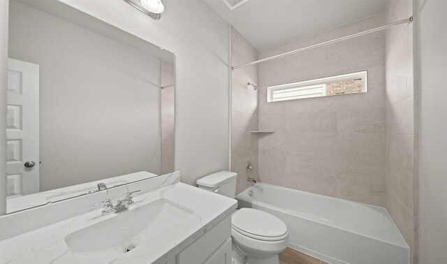 bathroom with vanity, toilet, and shower / bathing tub combination