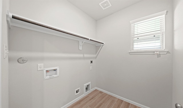 washroom featuring wood tiled floor, washer hookup, laundry area, hookup for a gas dryer, and electric dryer hookup