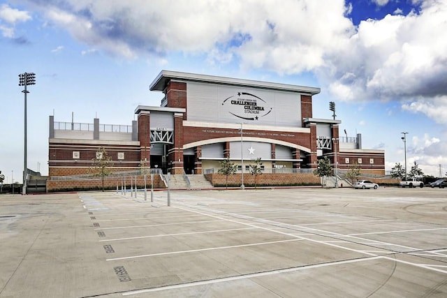 view of building exterior with uncovered parking