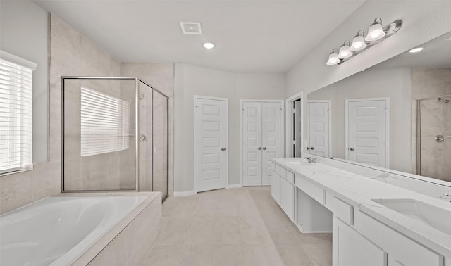 bathroom featuring a sink, a closet, a garden tub, and a shower stall