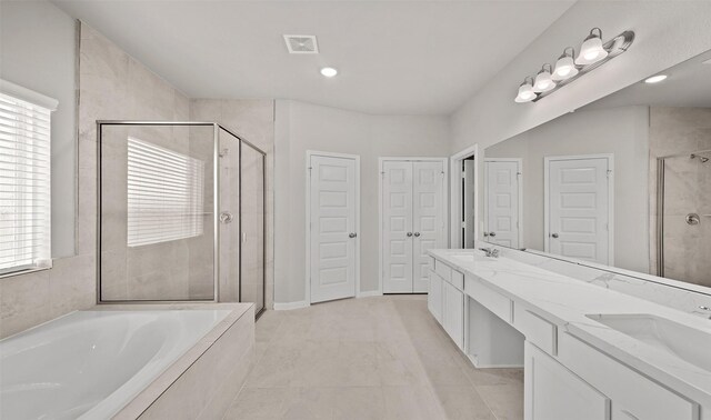 bathroom featuring a sink, a closet, a garden tub, and a shower stall