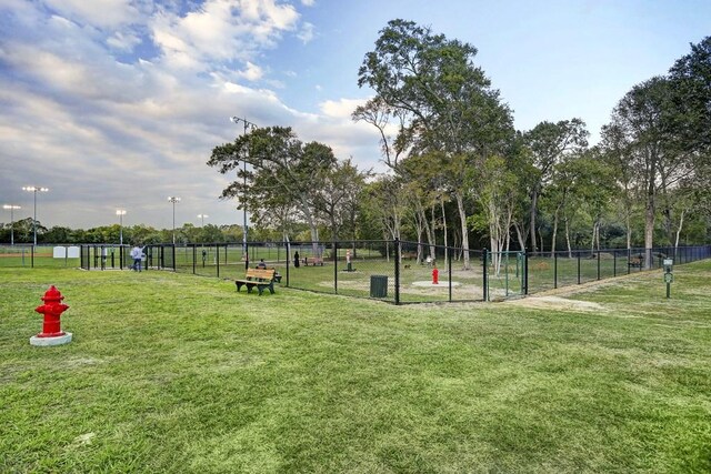 surrounding community featuring a yard and fence