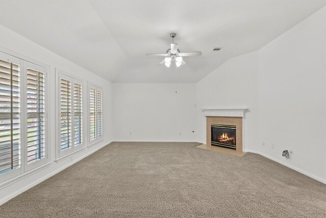 unfurnished living room with a ceiling fan, lofted ceiling, carpet, and visible vents