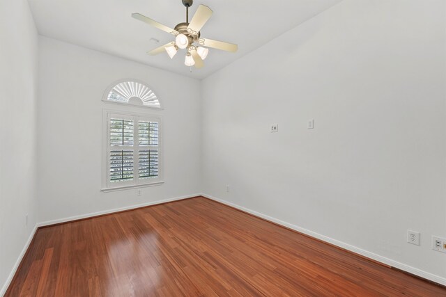 unfurnished room featuring ceiling fan, baseboards, and wood finished floors