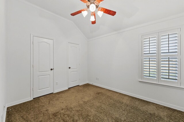 unfurnished bedroom with lofted ceiling, crown molding, baseboards, and carpet floors