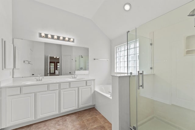 full bathroom with a bath, a shower stall, lofted ceiling, and a sink