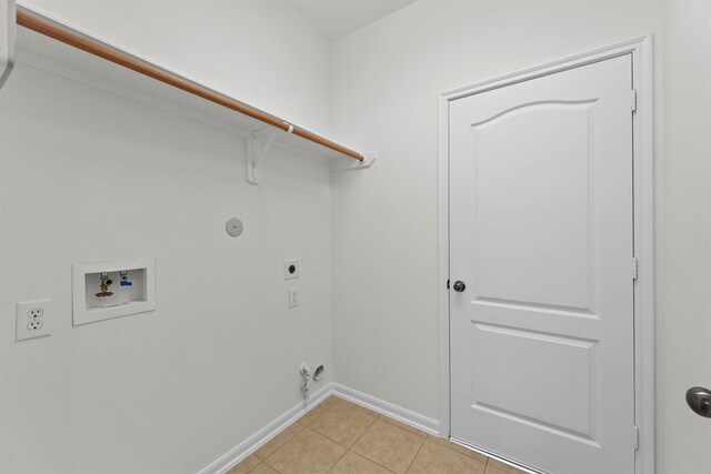 laundry area with gas dryer hookup, laundry area, hookup for a washing machine, light tile patterned flooring, and electric dryer hookup