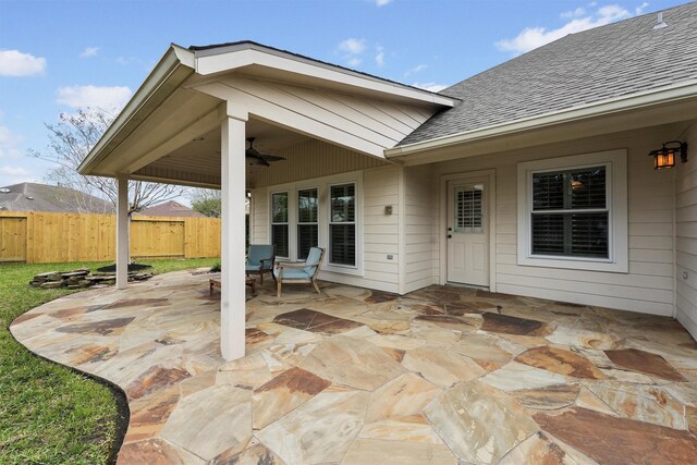 view of patio with a ceiling fan and fence