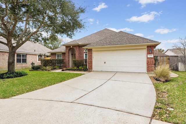 ranch-style house featuring brick siding, an attached garage, concrete driveway, and a front yard