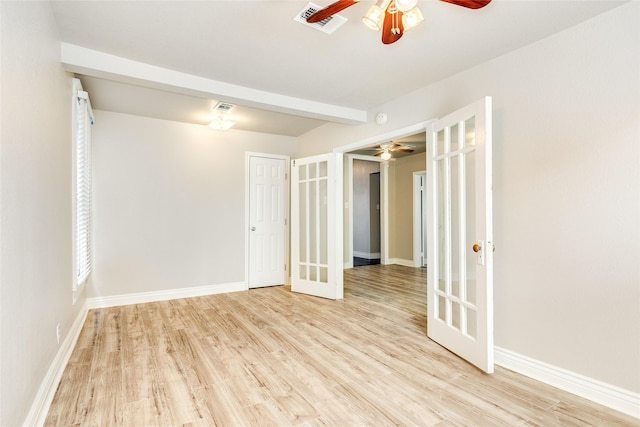 unfurnished room with visible vents, baseboards, ceiling fan, french doors, and light wood-type flooring