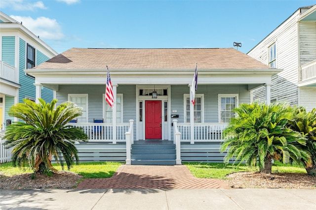 bungalow-style house with covered porch and roof with shingles