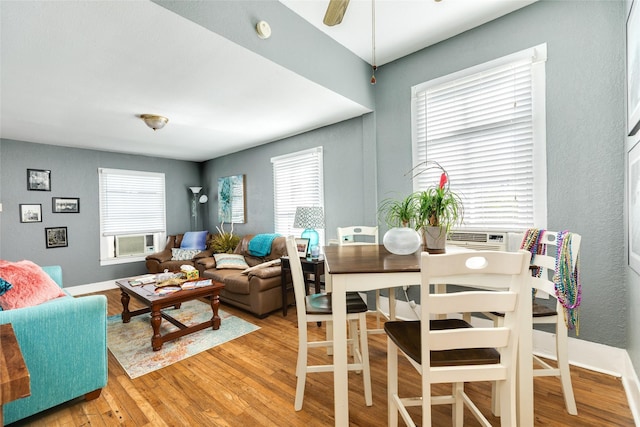 dining area featuring light wood-type flooring, baseboards, and ceiling fan