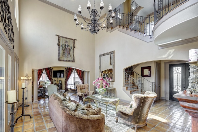 tiled living area featuring arched walkways, a healthy amount of sunlight, and stairs