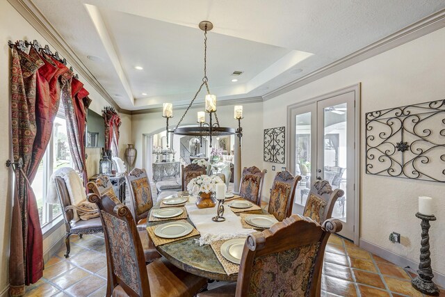 tiled dining area with a raised ceiling, crown molding, french doors, and visible vents