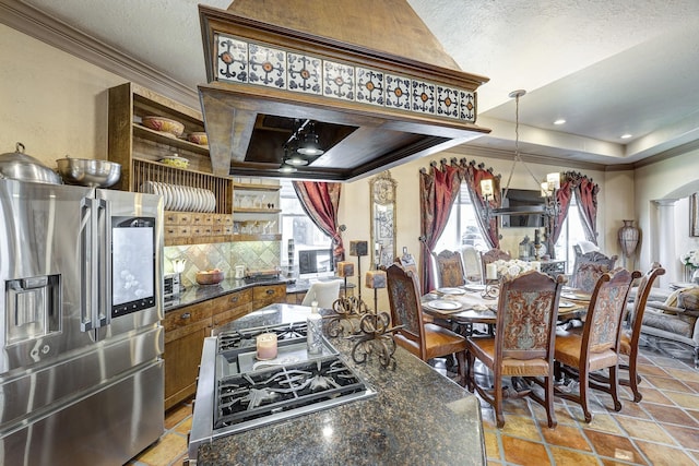 dining space with arched walkways, a textured ceiling, crown molding, and ornate columns