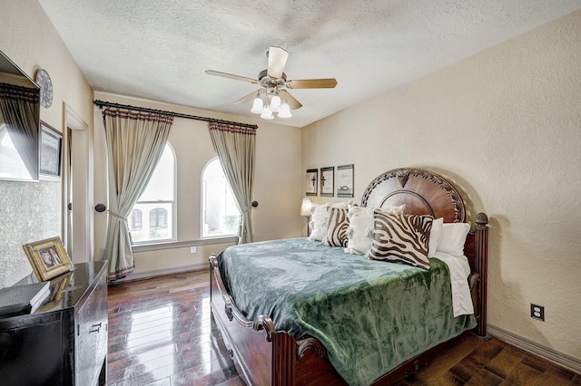 bedroom featuring a textured ceiling, hardwood / wood-style floors, baseboards, ceiling fan, and a textured wall