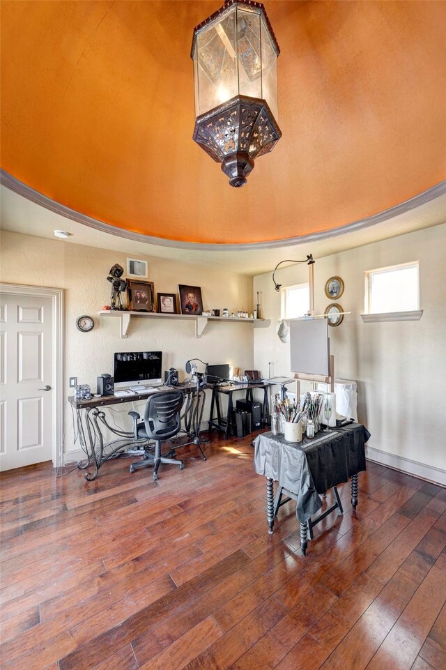 interior space featuring baseboards, visible vents, wood-type flooring, and built in study area