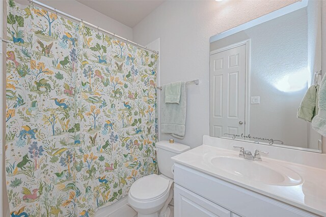 full bathroom with toilet, curtained shower, and vanity